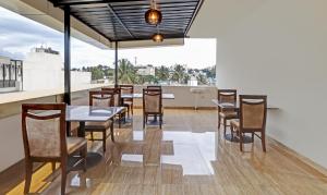 a dining room with a table and chairs at Treebo Trend Zion in Bangalore