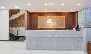 a lobby of a hotel with a reception desk at Treebo Trend Zion in Bangalore