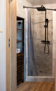a shower with a glass door in a bathroom at Przystań in Stalowa Wola