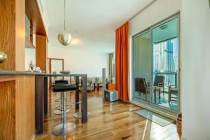 Burj Residences T3 Premium Apartment في دبي: مطبخ مع طاولة وغرفة طعام مع اطلالة