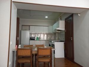 a kitchen with a table and chairs in it at Apartment Center 1 in Tashkent