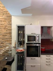 a kitchen with a stove and a microwave at Two Floor Luxurious Villa #skg in Thessaloniki