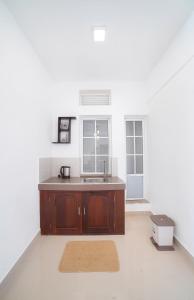 an empty kitchen with a sink and a window at The Montfort, Nuwaraeliya in Nuwara Eliya