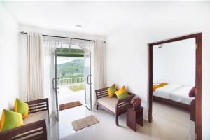 a bedroom with a bed and a mirror at The Montfort, Nuwaraeliya in Nuwara Eliya