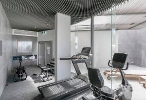 a gym with several exercise equipment in a room at 18OB Absolute Beachfront - Noosa Main Beach in Noosa Heads
