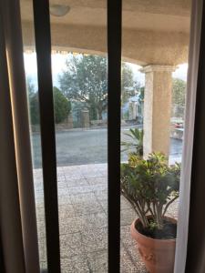 a view from a window of a porch with a potted plant at Studio de 39 m2 in Vezzani
