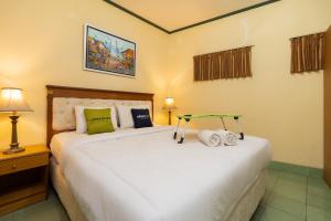 Postel nebo postele na pokoji v ubytování Urbanview Hotel Griya Astoeti 2 Cisarua Puncak + 20 fotografií