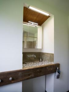 a bathroom with a sink and a mirror at Ferienhaus Laux in Weiskirchen +35 photos