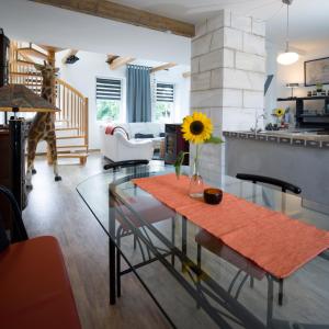 a living room with a glass table with a sunflower on it at Ferienhaus Laux in Weiskirchen