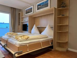 a bedroom with a bunk bed with shelves at Robbe in Westerland +23 photos