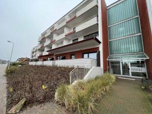 a building with a staircase in front of it at Robbe in Westerland