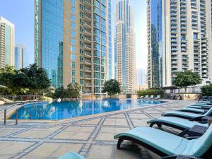 a swimming pool in a city with tall buildings at Burj Residences T3 Premium Apartment in Dubai