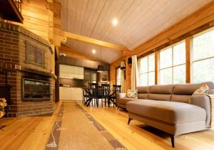 a living room with a couch and a fireplace at Ruhnu Holiday House in Ruhnu