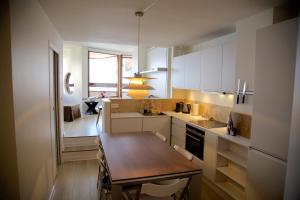 a small kitchen with a wooden table and a dining room at Munk - Avoriaz in Avoriaz