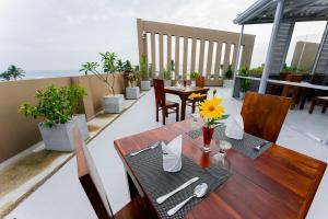 a table and chairs on the balcony of a house at Saffron Hotel Unawatuna in Unawatuna