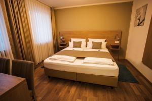 1 dormitorio con 1 cama grande en una habitación en Hotel & Restaurant Rizzelli Superior en Neustadt an der Aisch