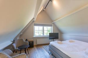 Een bed of bedden in een kamer bij Hello Zeeland - Appartement Brouwerijweg 43-1