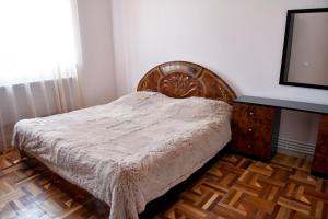 a bedroom with a bed and a dresser and a television at Manana Guesthouse in Marmarik