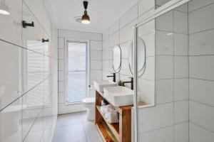 a white bathroom with a sink and a shower at Private Outdoor Spa, Fire Pit - THE RETREAT COOLUM BEACH in Coolum Beach +23 photos