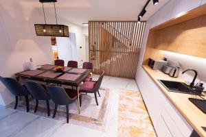 a kitchen and dining room with a table and chairs at Villa Coral in Vrelo Bosne