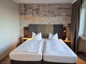 Postel nebo postele na pokoji v ubytování Hotel Bavaria Oldenburg