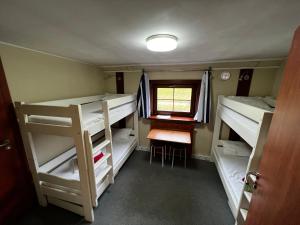 a small room with bunk beds and a window at The Boat - Hostel&Chill in Kraków