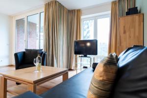 TV a/nebo společenská místnost v ubytování Wohnpark am Mühlenteich - Appartement 27