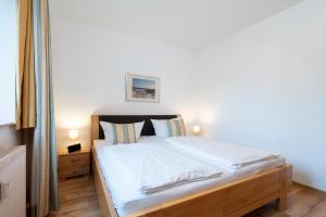 Postel nebo postele na pokoji v ubytování Wohnpark am Mühlenteich - Appartement 27