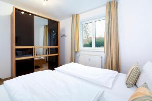 Postel nebo postele na pokoji v ubytování Wohnpark am Mühlenteich - Appartement 27