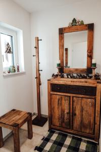 a bathroom with a wooden vanity and a mirror at Vulkanland Stoeckel - Feldbach in Feldbach