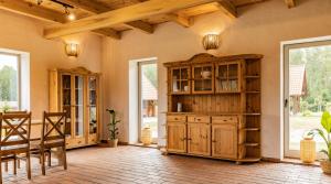 a living room with a wooden cabinet and windows at Apartament w Bukowej Chacie in Mörken