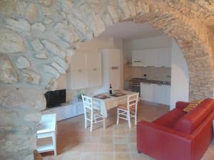a kitchen and a living room with a stone wall at Cà Del Polsèt in Brenzone sul Garda