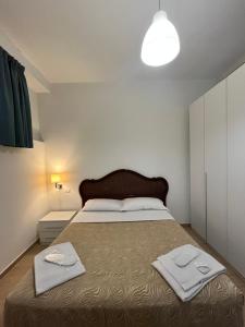 a bedroom with a large bed with two towels on it at Rucellai Guest House in Milan