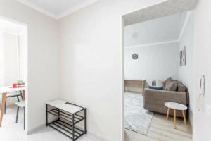 a white living room with a couch and a table at Шикарная квартира в Золотом квадрате in Almaty