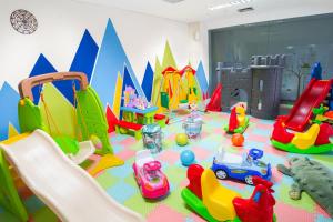 a childrens play room with many toys on the floor at Brits Hotel Legian in Seminyak