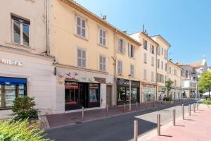 a street with shops and buildings in a city at Luxury Apartment 100 m to Palais des Festivals in Cannes