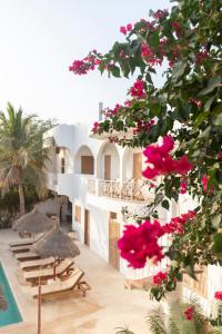 a view of a resort with pink flowers at Casa Louka in Saly Portudal