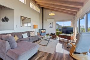 a living room with a couch and a tv at Otway Views in Apollo Bay