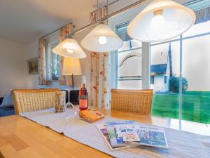 a table with a bottle of wine on top of it at Ferienhaus To Hus in Vieregge