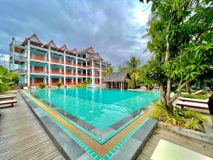 a large swimming pool in front of a building at Nakasang Paradise Hotel in Nakasong