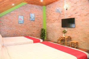 een slaapkamer met 2 bedden en een flatscreen-tv bij Lucky Home in Hue