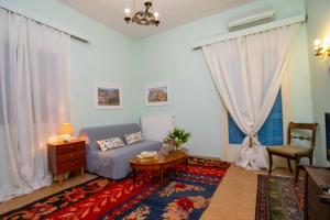 a living room with a couch and a table at Marina's Bright Getaway - Nafplio Center House in Nafplio