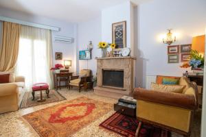 a living room with a couch and a fireplace at Marina's Bright Getaway - Nafplio Center House in Nafplio