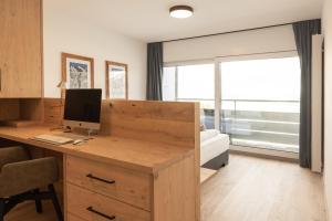Televízia a/alebo spoločenská miestnosť v ubytovaní Apartment Alpenblick