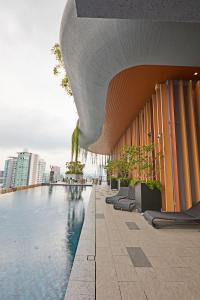 a building with a swimming pool next to a building at Romantic Log Cabin - walk to KL Tower, KLCC, Bukit Bintang in Kuala Lumpur