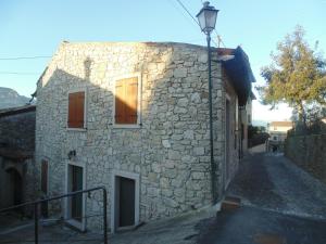a stone building with a street light next to it at Cà Del Polsèt in Brenzone sul Garda