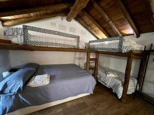 a bedroom with two bunk beds in a house at Casa Barranco in Júzcar