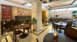 a restaurant with tables and chairs in a room at Olympus Mediterranean Boutique Hotel in Litochoro