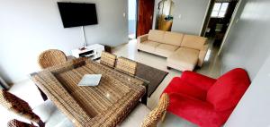 a living room with a table and a red chair at Mermel 4 - Sleeps 6 - Overlooking Margate Lagoon! in Margate