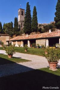 a building with a clock tower in the distance at B&B Borgo Tre Case in Cavriana